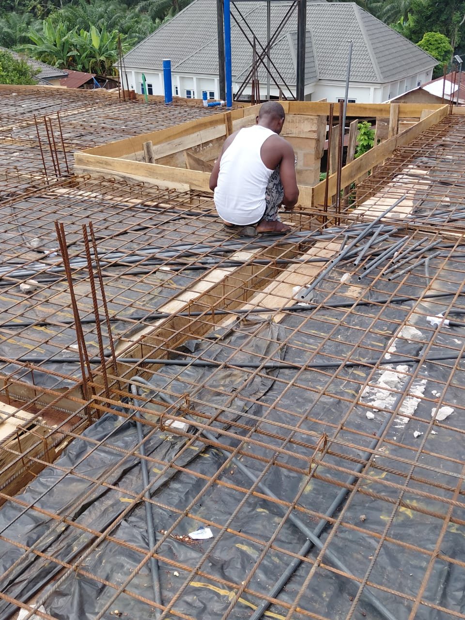Construction worker tying rebar on a roof slab formwork